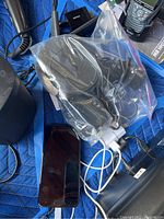 Samsung cell phone with various charging accessories including cables and chargers seen in bag.