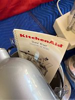 Close-up of the KitchenAid instruction manual inserted into the mixer.