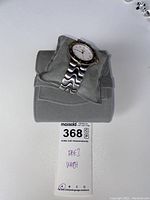 Watch front view on cushion showing case and bracelet