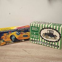 Photo showing both model car kit boxes side by side, International Sports Racer on left and 1925 Model T Ford on right.