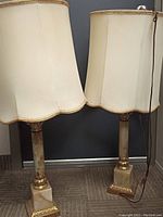 Pair of vintage plug-in stone stand lamps with cream fabric shades and gold trim, showing the height and overall look of both lamps.