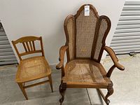 Pair of oak cane chairs: a large cane rocking chair on the right and a smaller cane desk chair on the left, showing overall condition and size difference.