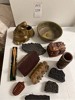Overview of wood blocks, carved box, wooden vase, brass bowl, brass holder, Finnish letter opener in case. Shows overall lot contents.