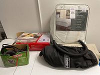 Shelf photo showing Coleman twin airbed in storage bag, electric QuickPump in box and Laura Ashley mattress topper in packaging.