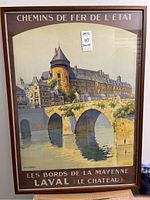 Full view of the framed French poster depicting a château and stone bridge scene over water.