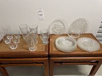 Full lot showing glasses and plates on wooden tables
