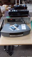 Bose Music System III with remote, Sanyo CD player RF5035, Panasonic clock radio stacked on table
