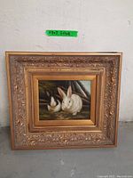 Full view of framed painting showing two rabbits
