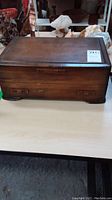 Closed wooden flatware case showing vintage condition and wood grain.