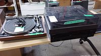 Audio Reflex and Dual 1245 turntables on table, shows dust cover and missing top