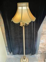 Full view of antique floor lamp with cream colored fabric lampshade and gold accents, standing approximately 65.5 inches tall.