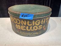 Front side view of the large metal tin labeled Moonlight Mellos in vintage lettering with The Patterson Candy Co. branding.