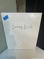 Photo of the white scrap book cover labeled 'Scrap Book' with 'ART' written in corner