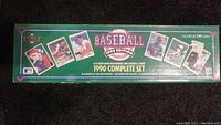 Top and side view of the green 1990 Upperdeck Baseball Card Factory Set box showing the branding, edition, and some player card images.