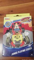 Front view of the Disney Mickey Mouse Roadster Racers jumbo playing cards box showing the colorful design and Mickey Mouse driving a yellow car with the number 28.