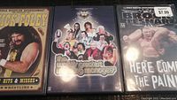Three WWF wrestling DVDs side by side: Mick Foley Hits & Misses, The Ultimate Greatest Wrestling Managers, and Brock Lesnar Here Comes the Pain.