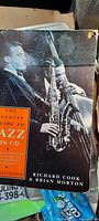 Front cover of the book showing black and white picture of jazz musicians and orange title block with book title and authors.
