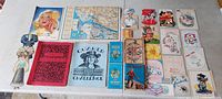 Group of papers including two Quaker Challenge booklets, vintage greeting cards, a map, and other antique paper collectibles spread on a surface.