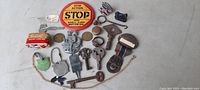 Photo showing entire lot with keys, toy car, ring, pins, tokens, and other small collectibles arranged on a surface.