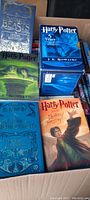 Overview of the five Harry Potter related books including the 3-book set in a sleeve box and individual titles.