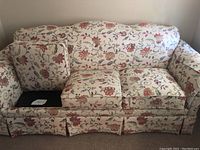 Front view of three-seat floral patterned sofa showing full profile