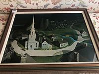 Full view of the large framed print showing a rural village scene at night with church steeple and houses
