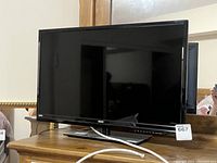Front view of the RCA 28-inch flat screen TV showing the screen and stand.