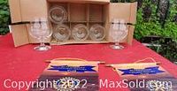 Set of 6 Bellevieu Kiek glasses displayed on table, behind open packaging box, outdoors setting.