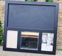 Photo of the dark wood collage picture frame outdoors showing photo slots and small mirror with wear.