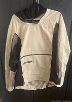 Beige and black insect-repellent Original Bug Shirt jacket hung on hanger