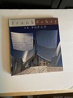 Front cover of Frank Gehry in Pop-up book showing metallic curved panels of Gehry's architecture.