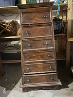 Front view of the pyramid chest of drawers showing six drawers and overall structure.