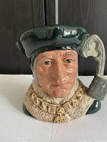 Front view of Royal Doulton Sir Thomas More jug, showing detailed face and hat.