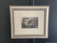 Black and white framed print showing Wolfe's Cove by W.H. Bartlett with ornate silver frame visible.