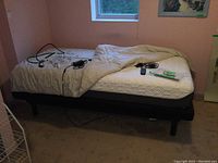 Assembled adjustable bed frame with mattress and comforter