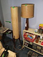 Both lamps side by side against wall, floor lamp on left and table lamp on right