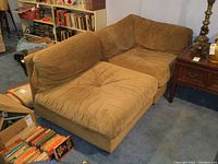 Two sections side by side; tufted seats and brown microfiber upholstery visible