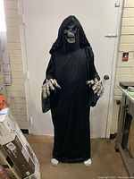 Front view of adult demon Halloween costume including robe, mask, and gloves displayed on mannequin.