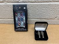 Box of Nightmare Before Christmas themed press-on nails with 12 sizes and 24 pieces shown in packaging.