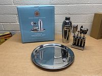 Martha Stewart Collection 7-piece barware set, new in box with all pieces displayed including cocktail shaker, bar tools on stand, and serving tray.