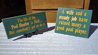 Photo showing both vintage pool/billiards game room wood signs with humorous quotes on green background and yellow text.