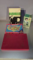 Lot showing Business Strategy game, US puzzle map, Sears microscope box, and red box (Scrabble RSVP)