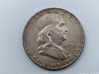 Front side of the 1952 Franklin Half Dollar showing Benjamin Franklin with visible dirt and wear.