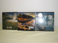 Front view of all three sealed Canadian Stamp Collection albums from 1998, 1999, and 2000, each with distinct nature-themed photographic covers.