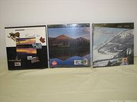 Front view of all three stamp albums showing 1995, 1996, and 1997 editions with Canadian-themed covers.