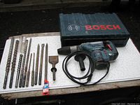 Overview of Bosch carrying case, rotary hammer drill, side handle and drill bits