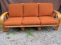 Three-seat rattan settee with cushions front view