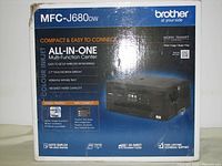 Front of box showing model number MFC-J680DW, brand Brother, and feature highlights including all-in-one functionality, touchscreen display, wireless networking, duplex printing, and mobile printing support.