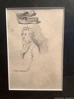 Close-up photo of pencil sketch showing detailed profile of an older bearded man with shoes above and signature of A.B. Davies.