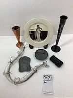 Full lot view showcasing all seven pieces including Bacardi plate, black vase, copper vase, glass horn, and other decorative items